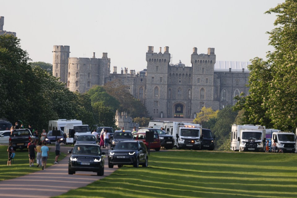 Prince Andrew drives past travellers who set up a caravan camp outside Windsor Castle yesterday