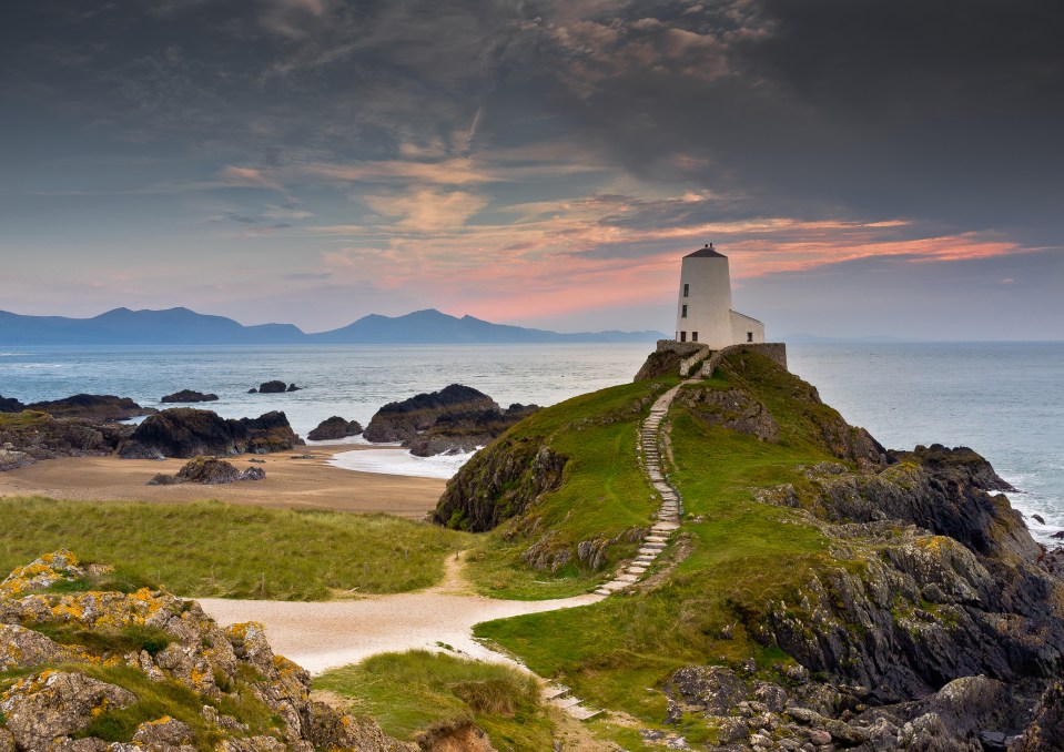 Sunset over Llanddwyn Island on Anglesey, with mountains of Snowdonia in the background