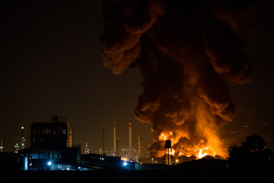 The oil refinery continued to burn into a second day as firefighters struggled to extinguish the flames