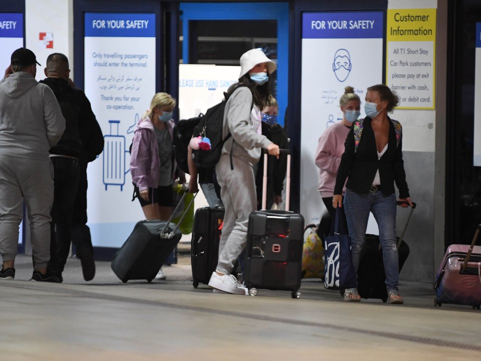 The first passengers fly in to Manchester Airport from Faro, Portugal, after the UK Government announced it was to be removed from the green list