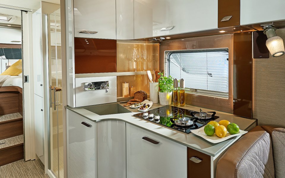 The kitchen is beautifully designed with white cupboards