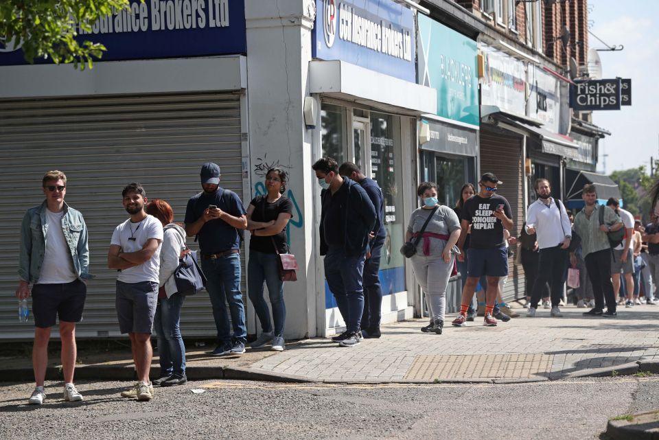 People queuing to go into Belmont Health Centre in Harrow, Greater London, for Covid vaccines