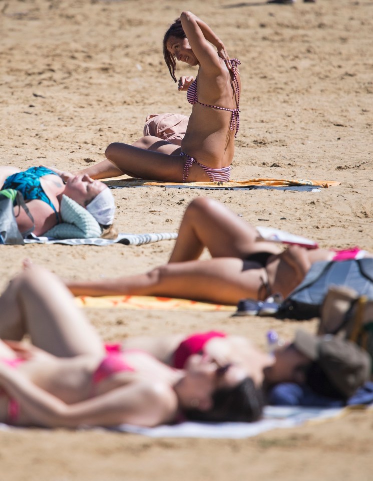 People relax in the hot weather at Ruislip Lido northwest London