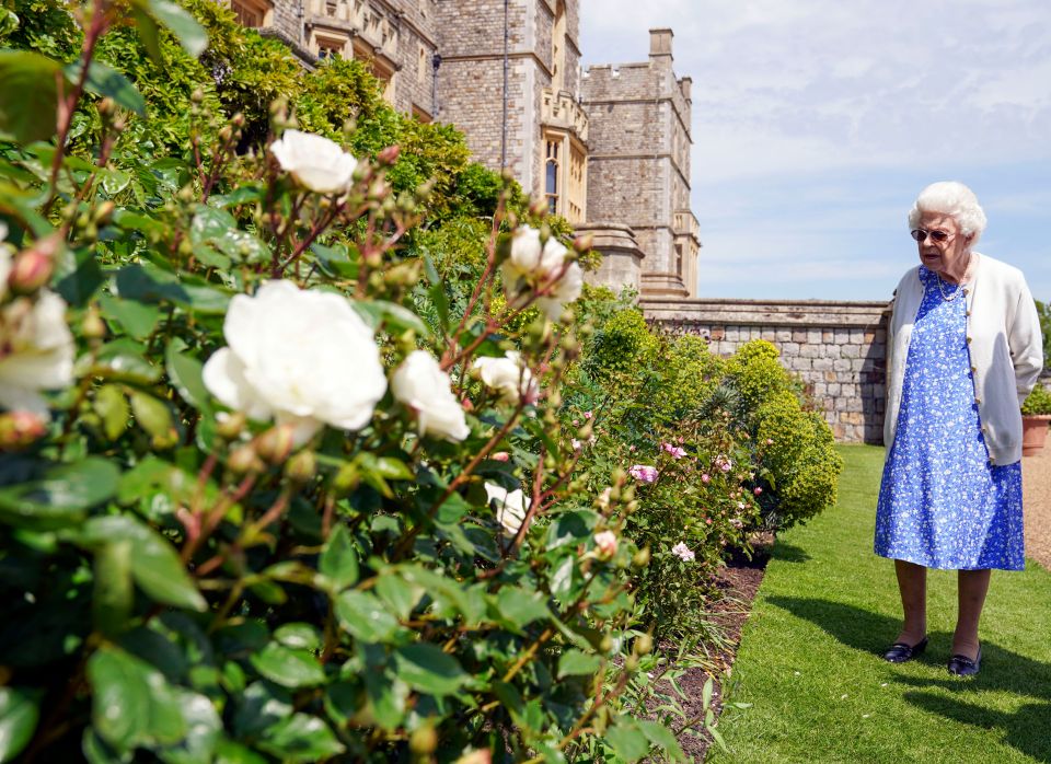 The Queen wore shades and a blue floral dress with white cardigan for the visit