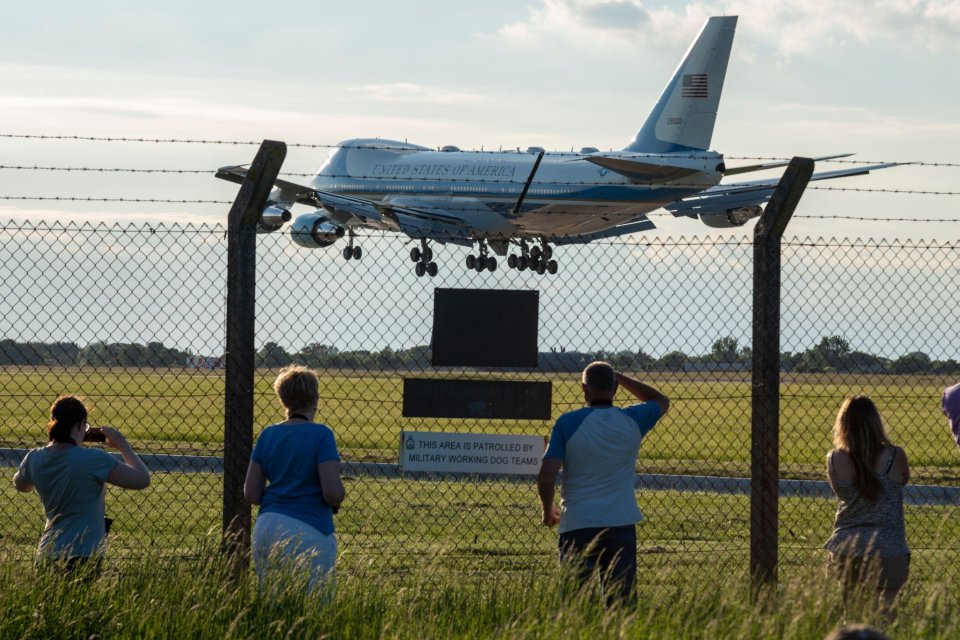 Onlookers watch as the President landed in the UK