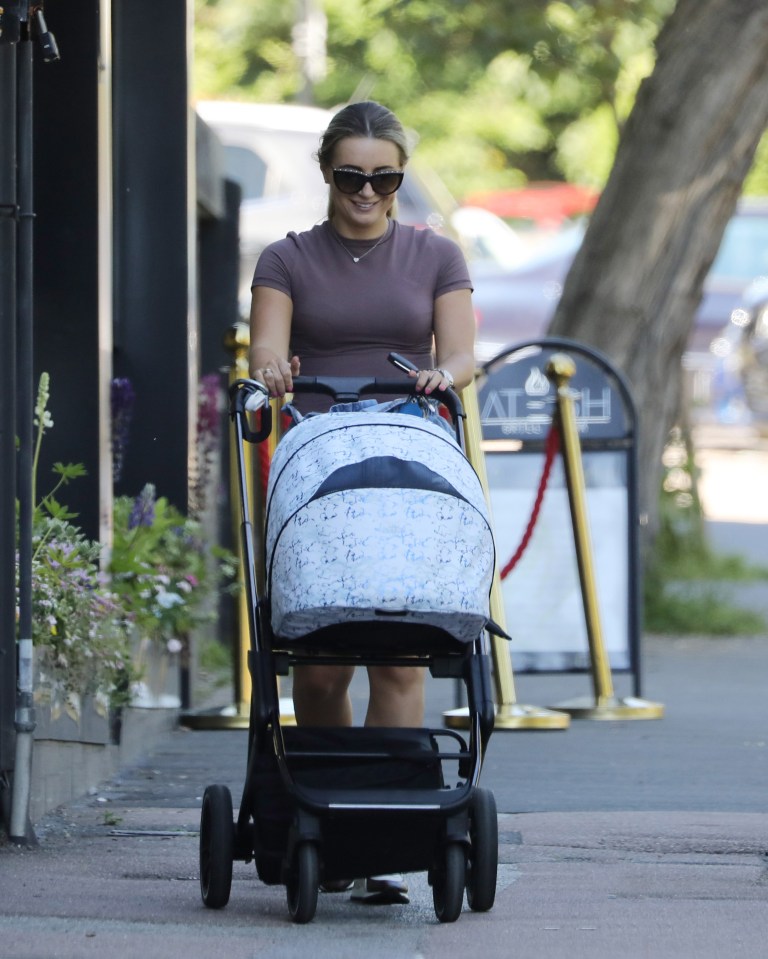 Dani smiled at baby Santi in the pram