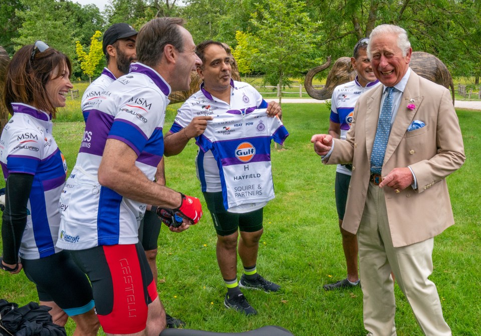 The Prince of Wales giggled as he was handed a tiny piece of lycra