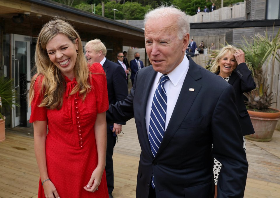 Carrie giggles as Biden puts his arm around her at the key summit today