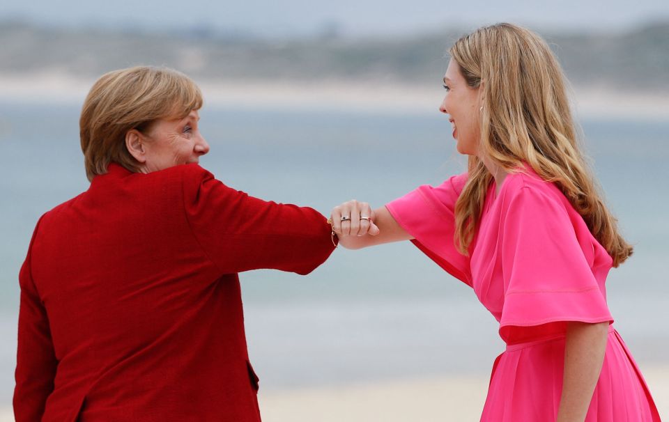 Carrie Johnson greets German Chancellor Angela Merkel with an elbow bump