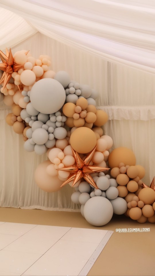 Balloons in blue, pink and neutral colours filled the gazebo