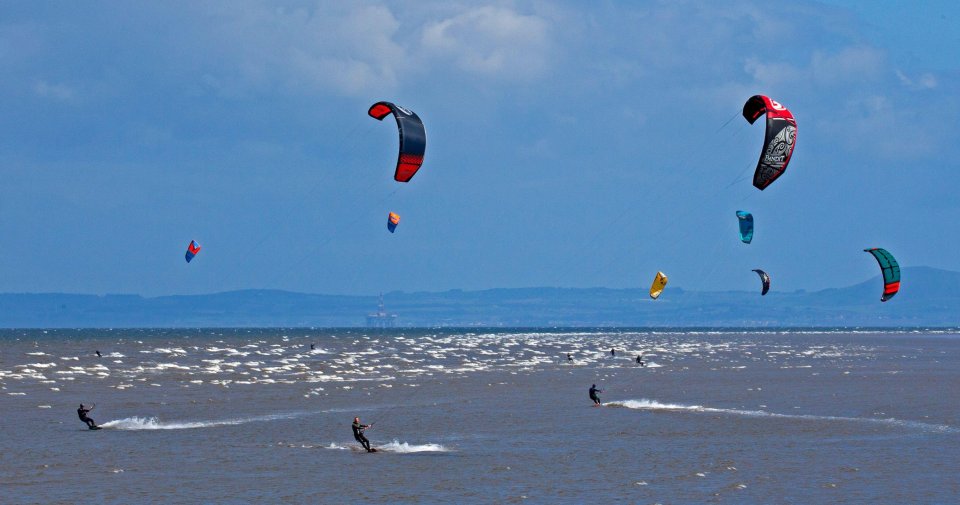 Kite surfers demonstrate their skills on the Firth of Forth