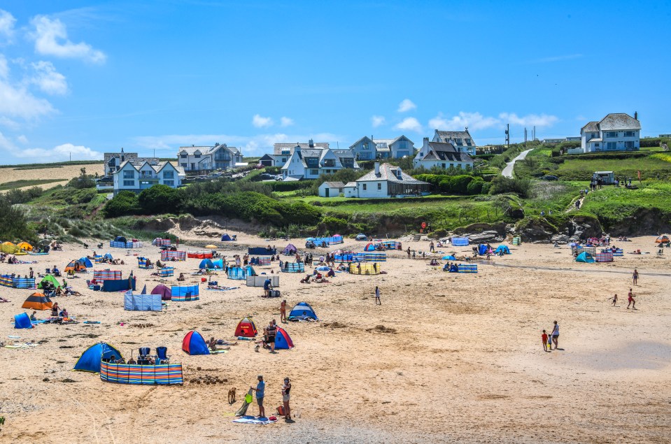 People enjoying the hot weather on the beach at Treyarnon near Padstow in Cornwall