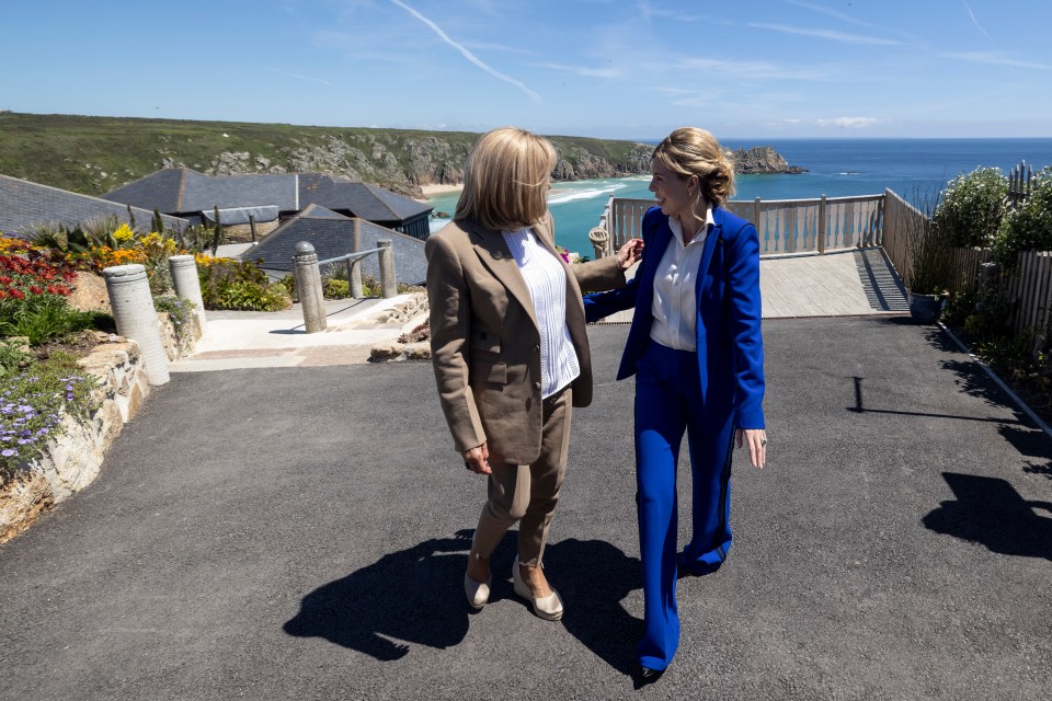 Carrie Johnson talks with Brigitte Macron, the wife of French President Emmanuel Macron