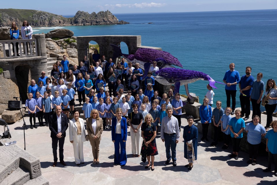 In Porthcurno, Carrie Johnson poses with the partners of G7 leaders and the performers of ‘Ocean World’ at the Minack Theatre