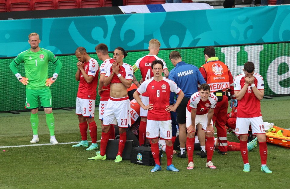 Christian Eriksen's worried team-mates look on as he receives treatment on Saturday night