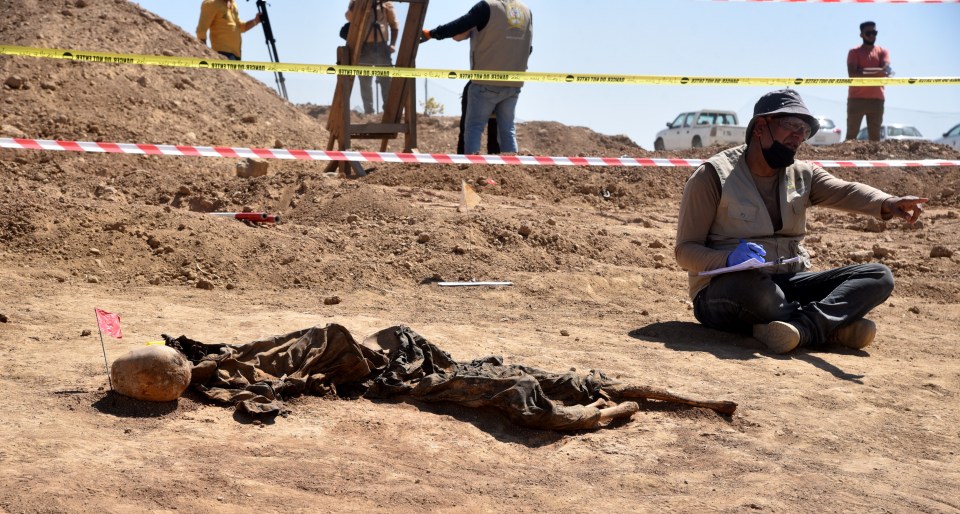 The remains of up to 12,000 people are believed to be buried in the graves, the UN says