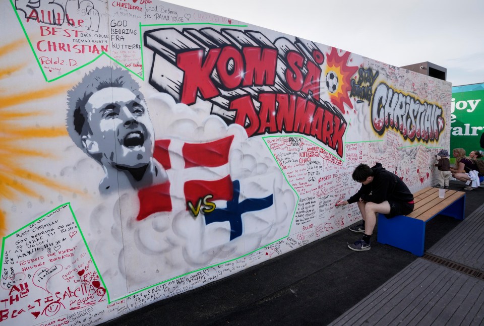 The football world has come together to wish the midfielder well, including this wall set up for fans' messages at Ofelia Beach in Copenhagen