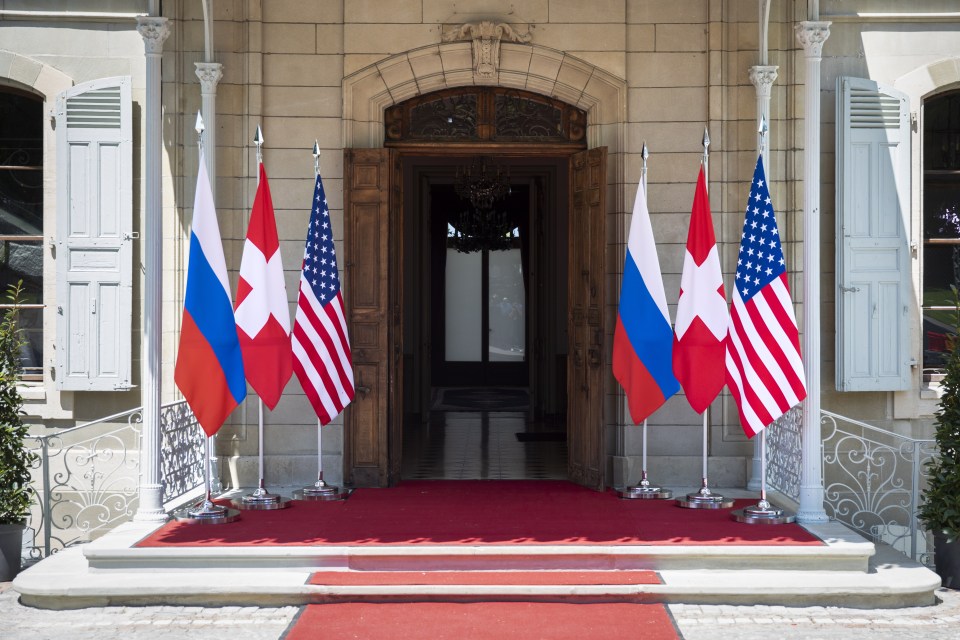 Flags of the US, Russia and Switzerland photographed in front of the entrance of the villa La Grange