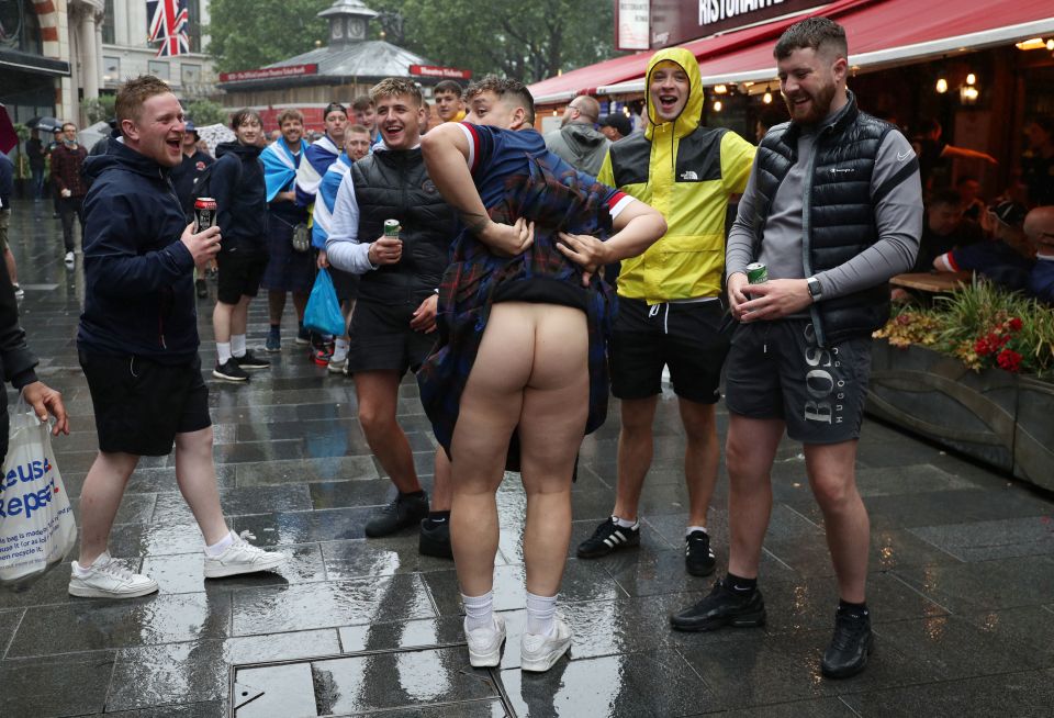 One lad shows his Scottish credentials off by baring his backside