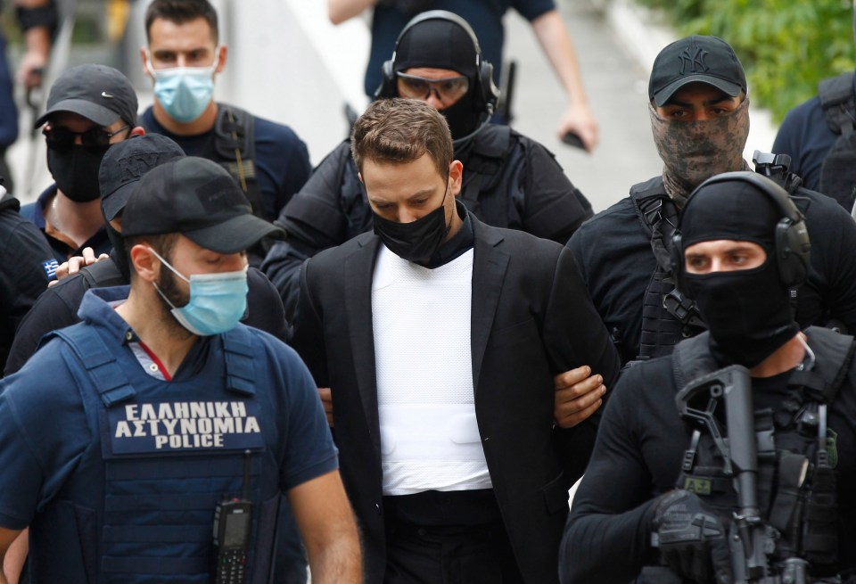 Babis Anagnostopoulos is led away by cops after confessing over Caroline's death