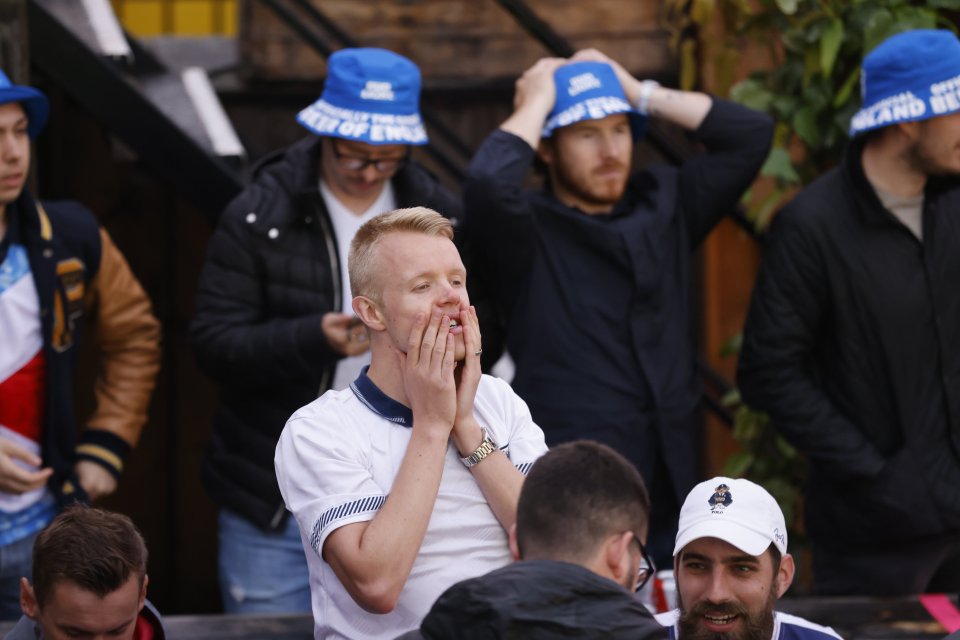 Fans watch the match from the Skylight Rooftop Bar at Tobacco Dock in East London