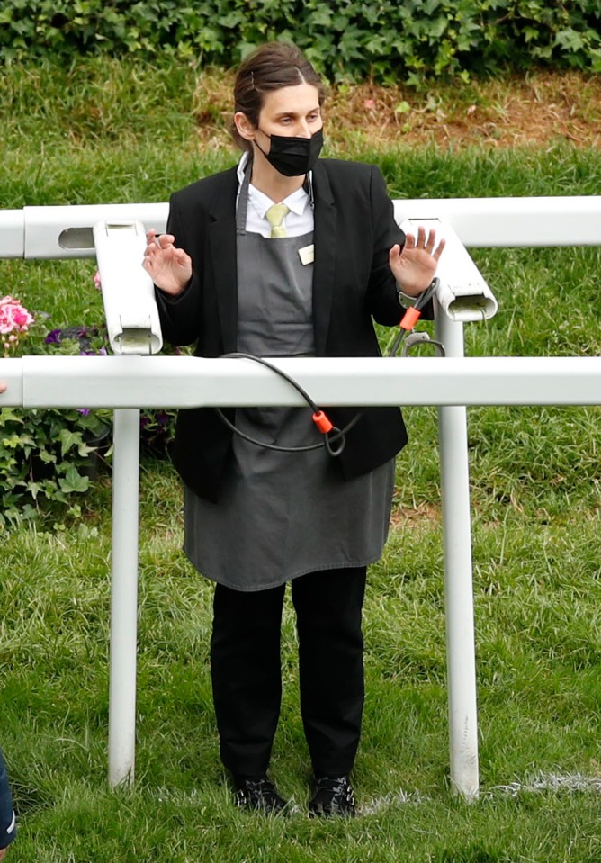 One of the climate activists was chained to the plastic rail by the finishing post