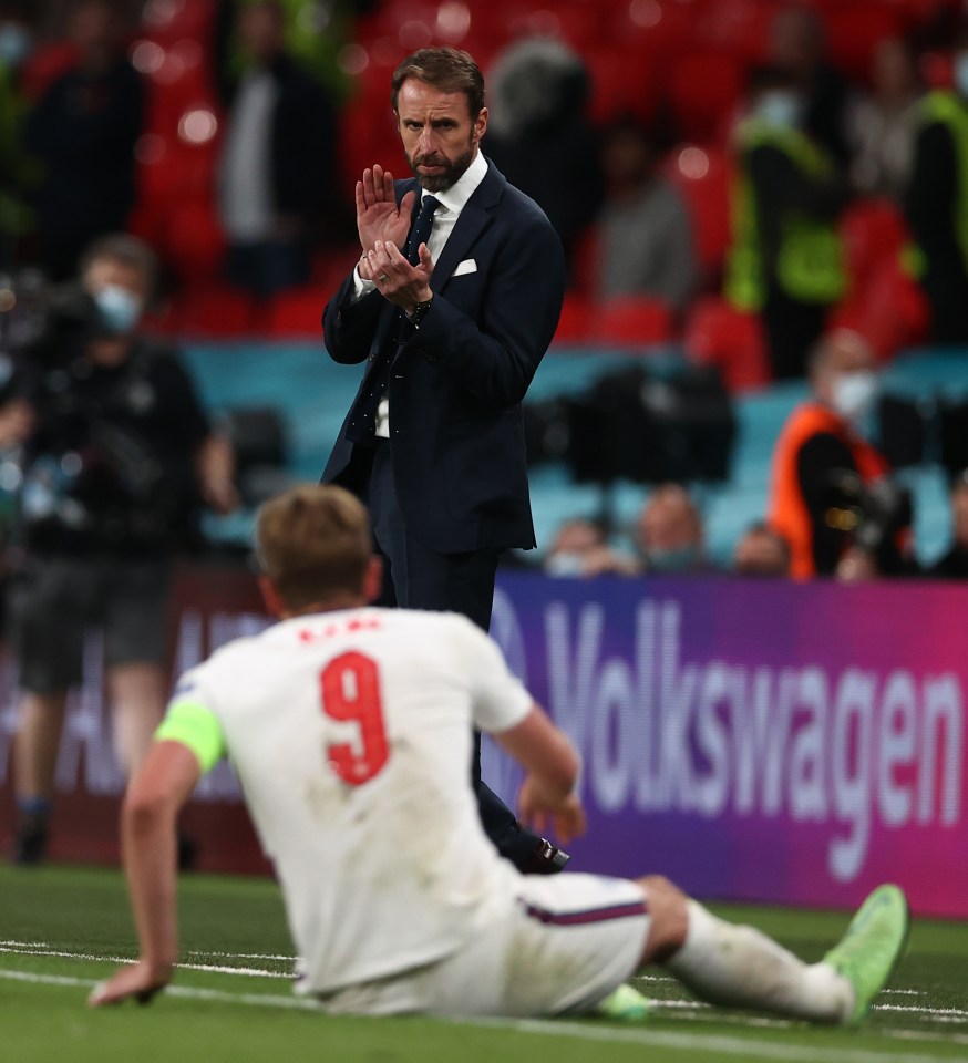 Harry Kane gets some encouragement from the boss after a much better performance