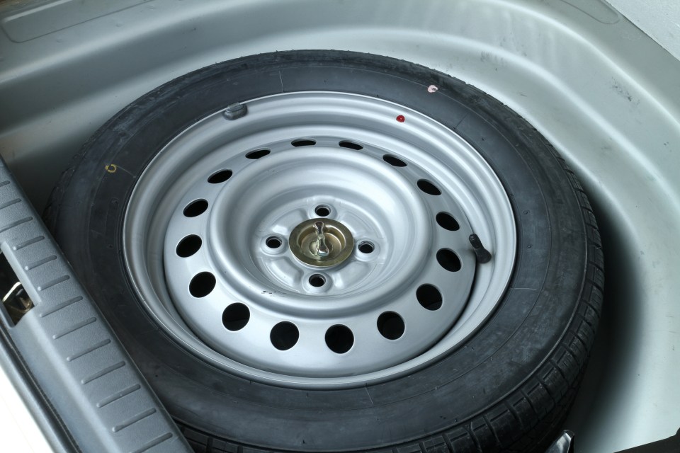 a spare tire in the trunk of a car