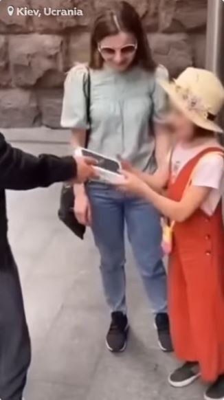 The Tiktok influencer is seen handing the girl a new phone