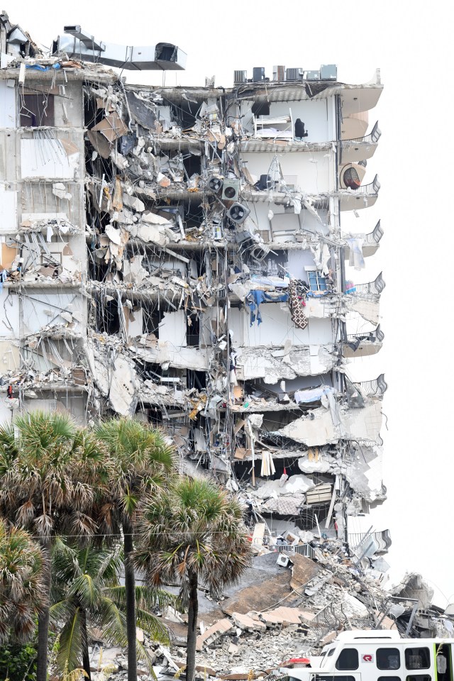 Mangled wreckage shows air conditioning units and bunk beds dangling from the building