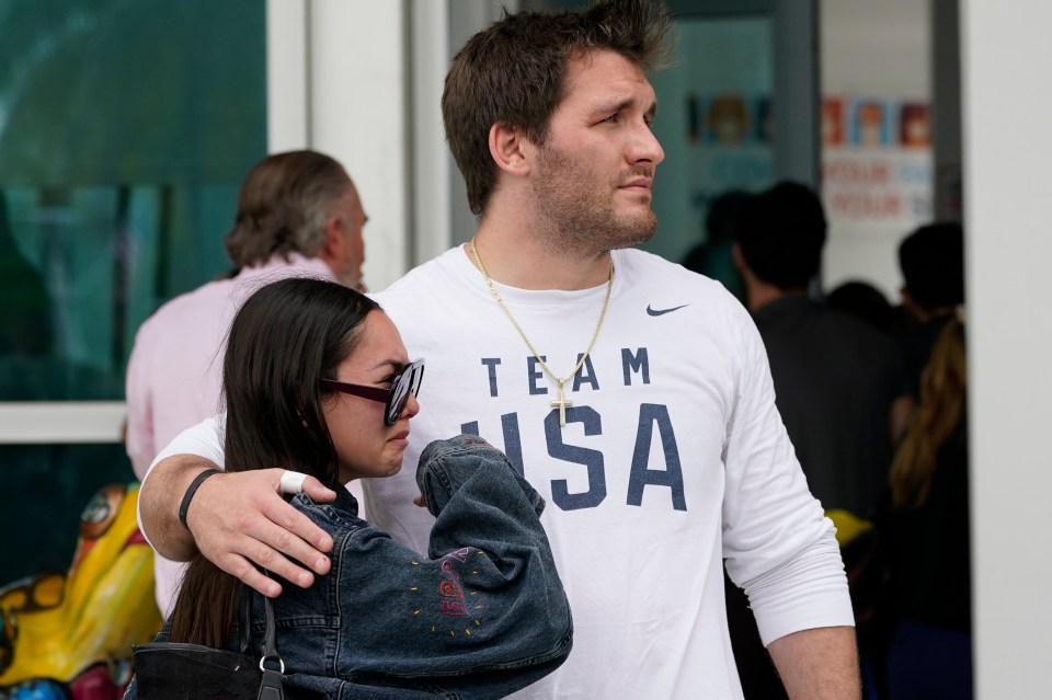 Floridians console each other as they wait for information