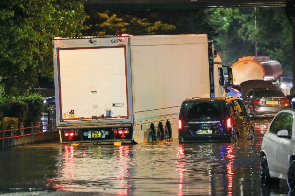 Drivers tried to navigate through the floodwaters