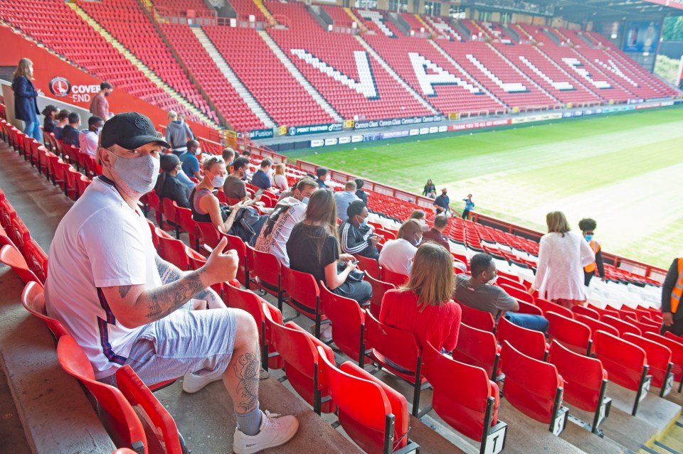 Young people at Charlton's The Valley stadium wait for their jabs