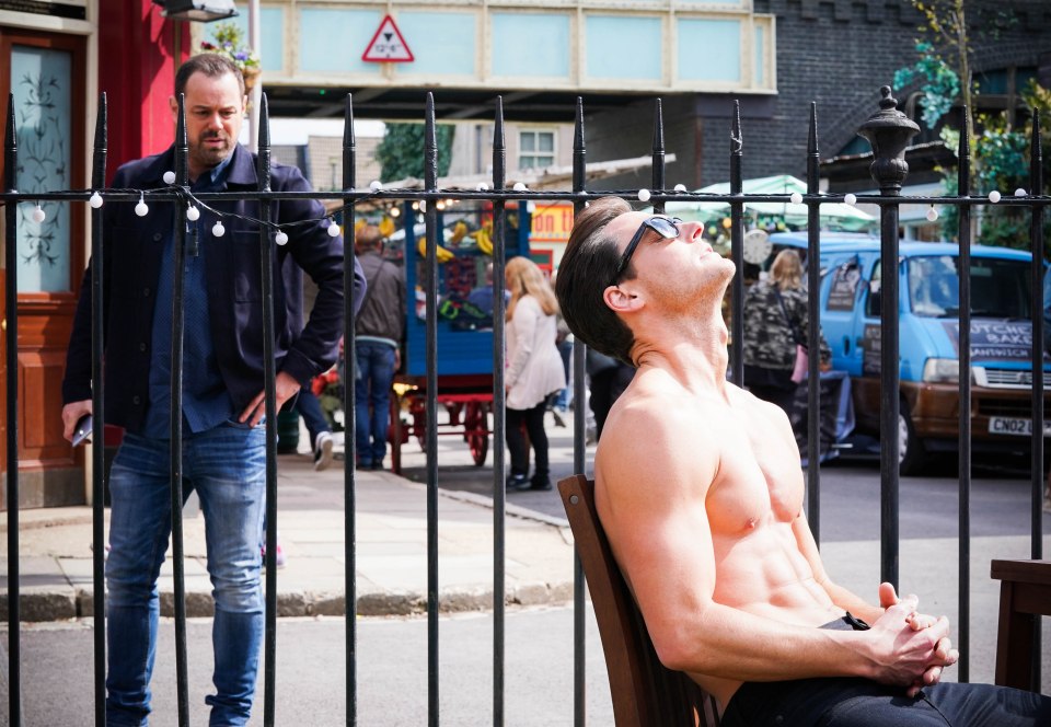 Zack Hudson, played by James Farrar, shows off his abs while sunbathing in Albert Square