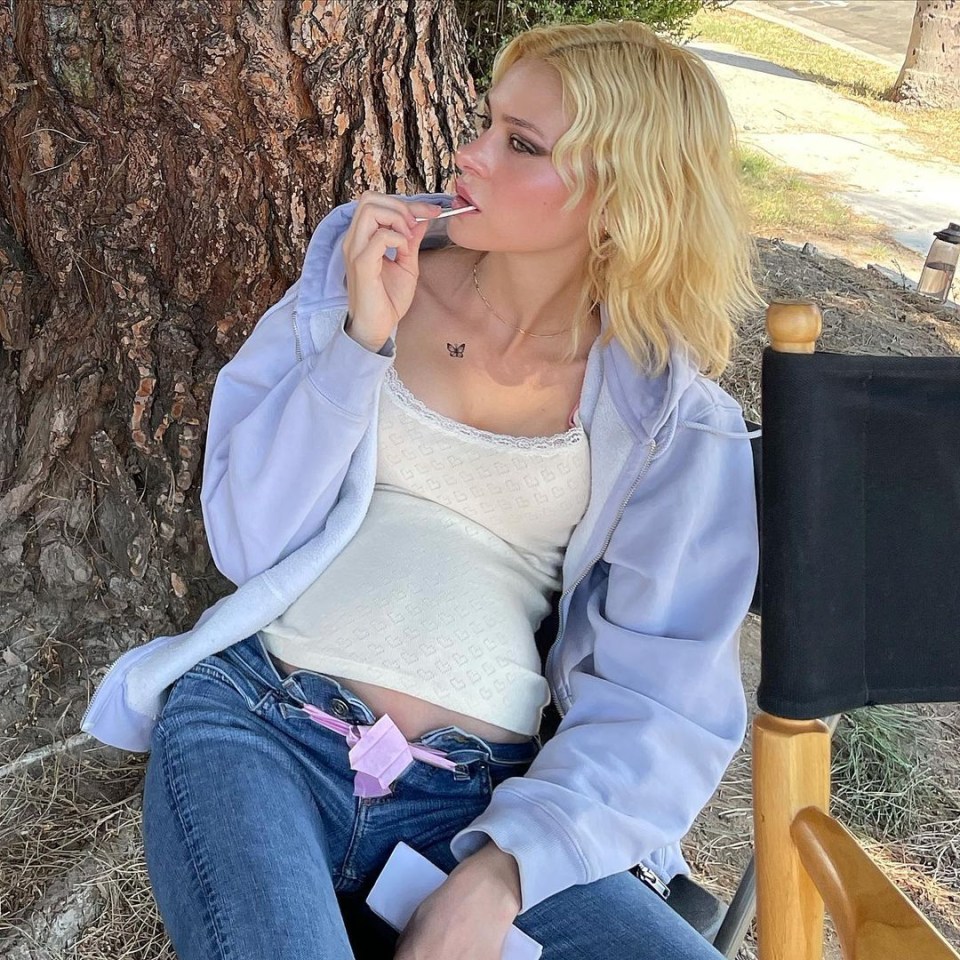 Nicola Peltz poses with a baby bump on the set of her new film Lola James