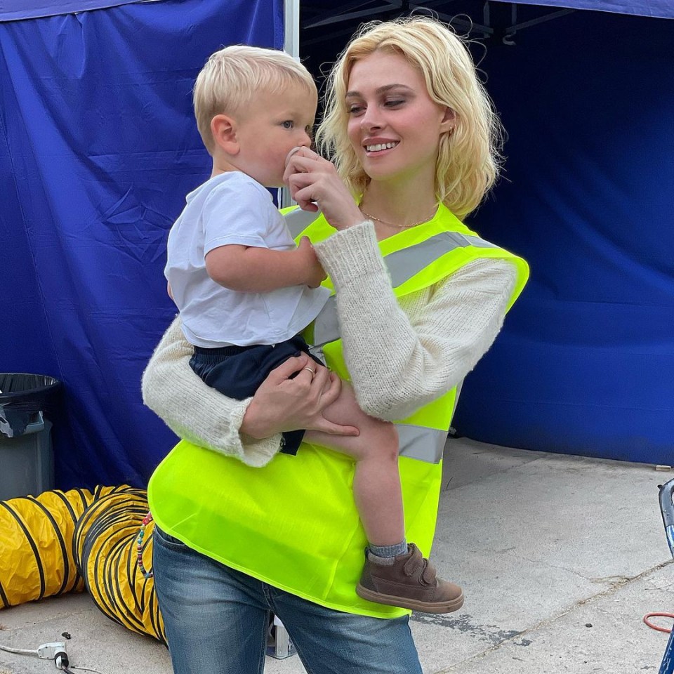 She poses with a child on set