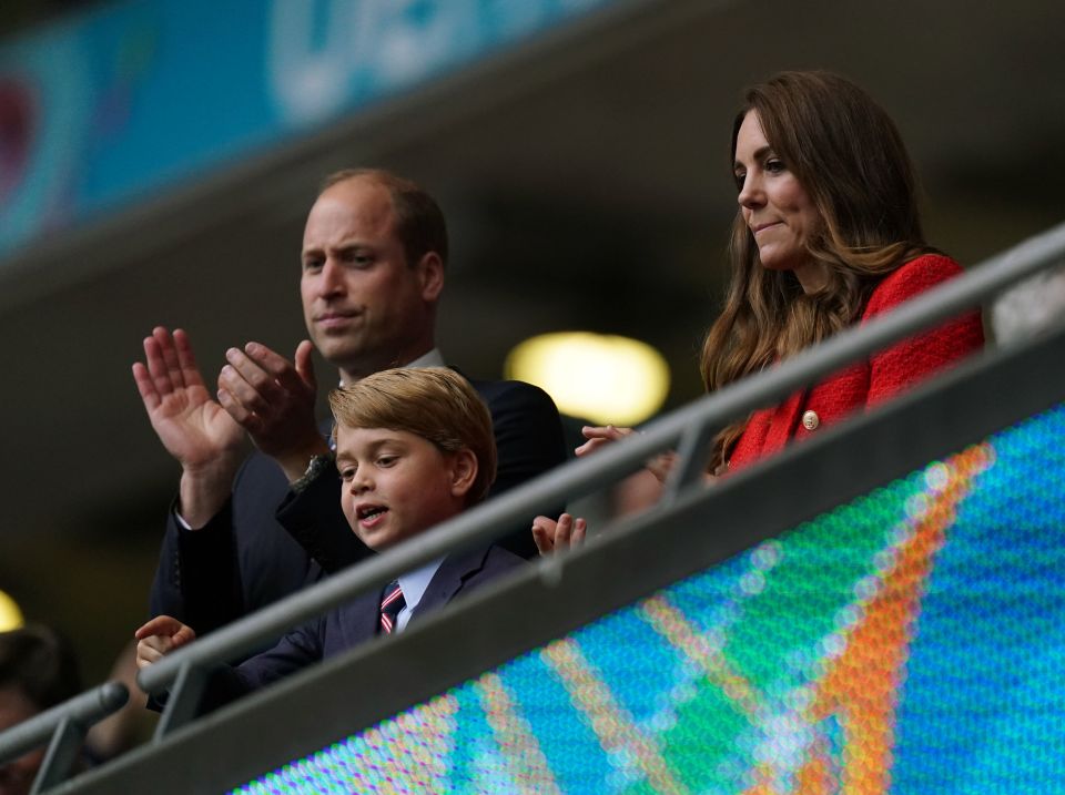 Prince George peers over the rail to catch a glimpse of the game