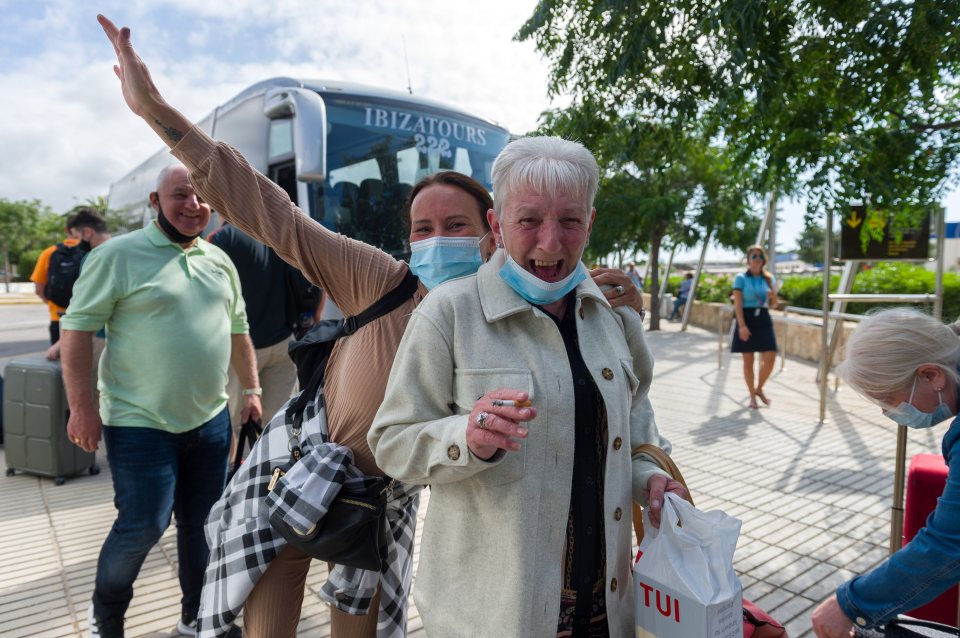 Brits grin for the cameras as they arrive in Ibiza today