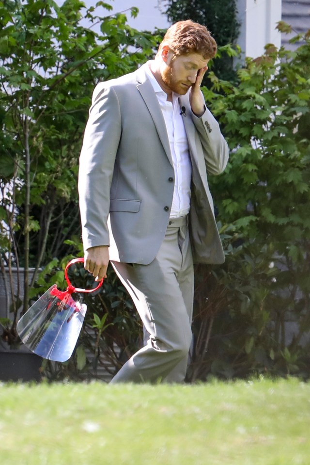 Other photos taken during shooting show Dean in a grey suit and white shirt - similar to the outfit worn by Harry in the couple's interview with Oprah