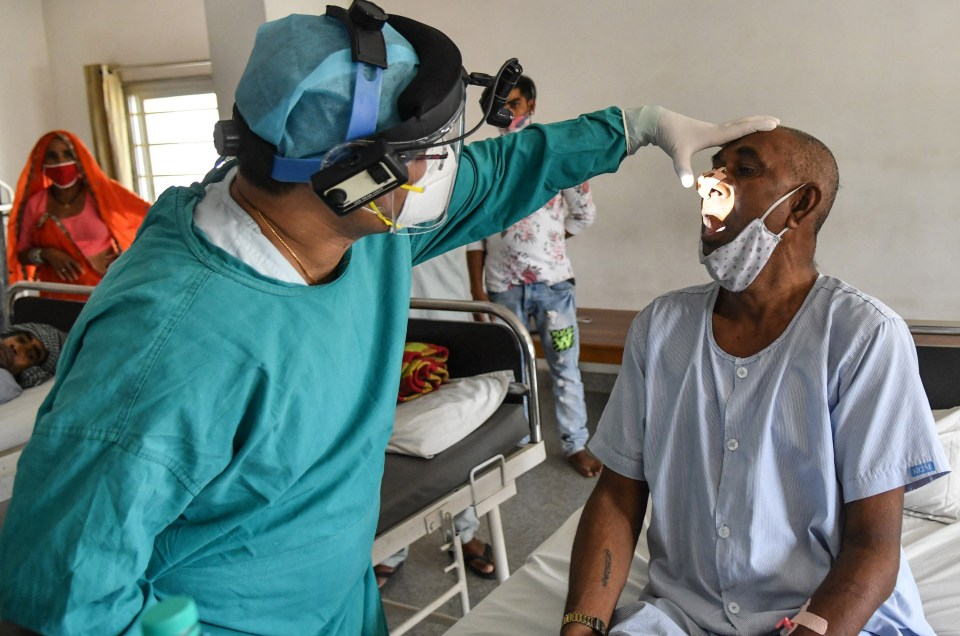 A specialist doctor examines a black fungus patient in Rajasthan