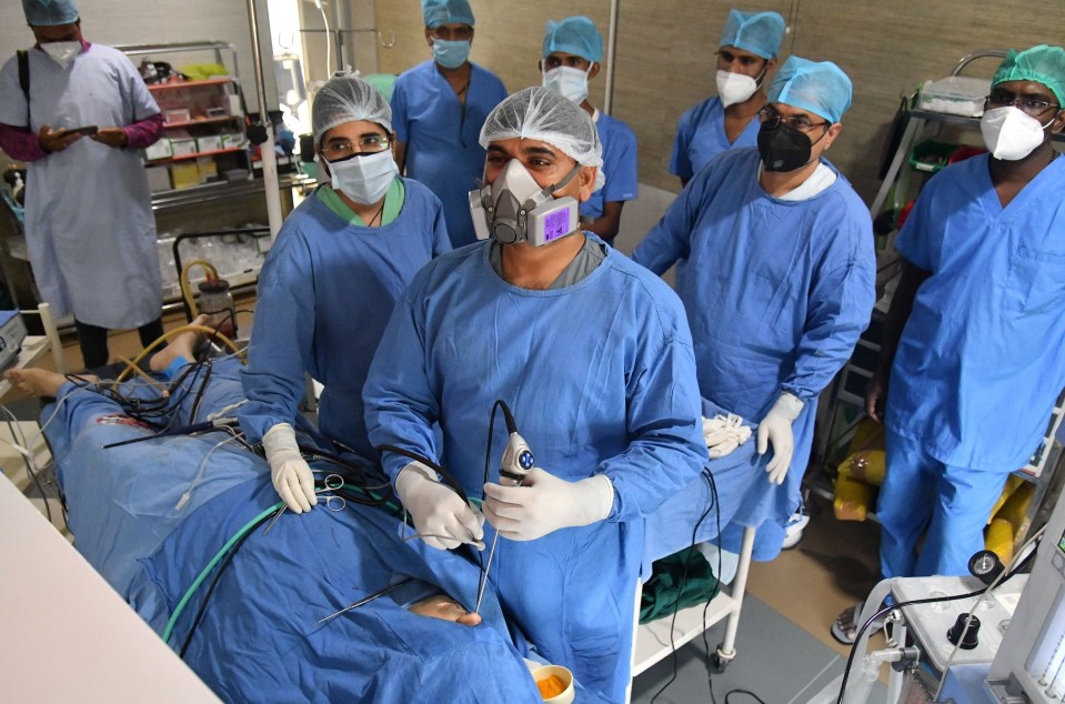 Dr Vijay Gakhar operates on a black and white fungus infected patient, at a hospital in Ajmer, May 29