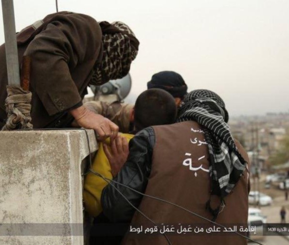 ISIS militants prepare to toss a gay man from a rooftop during their reign in Raqqa