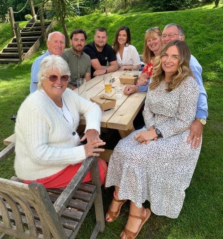 Fudge pictured with his beloved family including wife Jane (back right), daughter Paige (front right) and son Clark (second from back left)