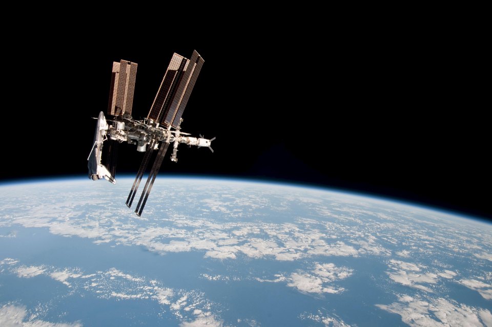 At least 10 small black objects flying right below the ISS camera as the craft was travelling above the Atlantic Ocean