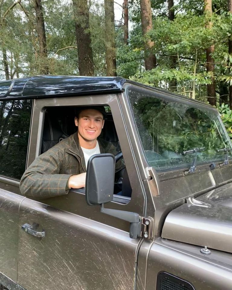 He posed grinning behind the wheel of a Land Rover in Scotland