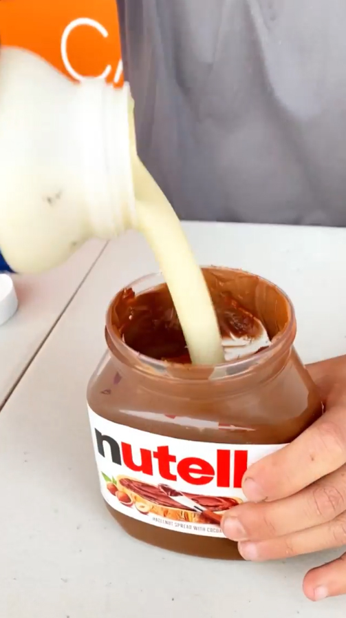 He filled the tub of Nutella up to the top with cream