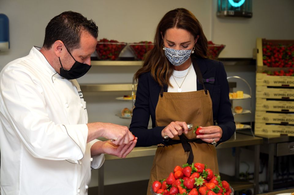 Kate helps to prepare strawberry desserts in the kitchens during her official visit on day five of Wimbledon