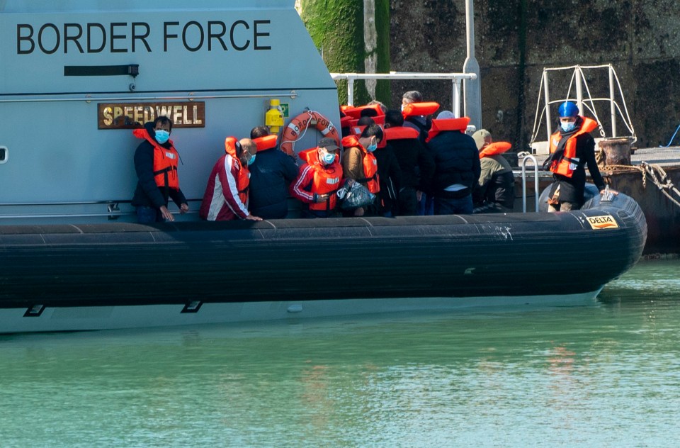 A load of around thirty migrants disembark from Border Force boats at Dover harbour earlier this month