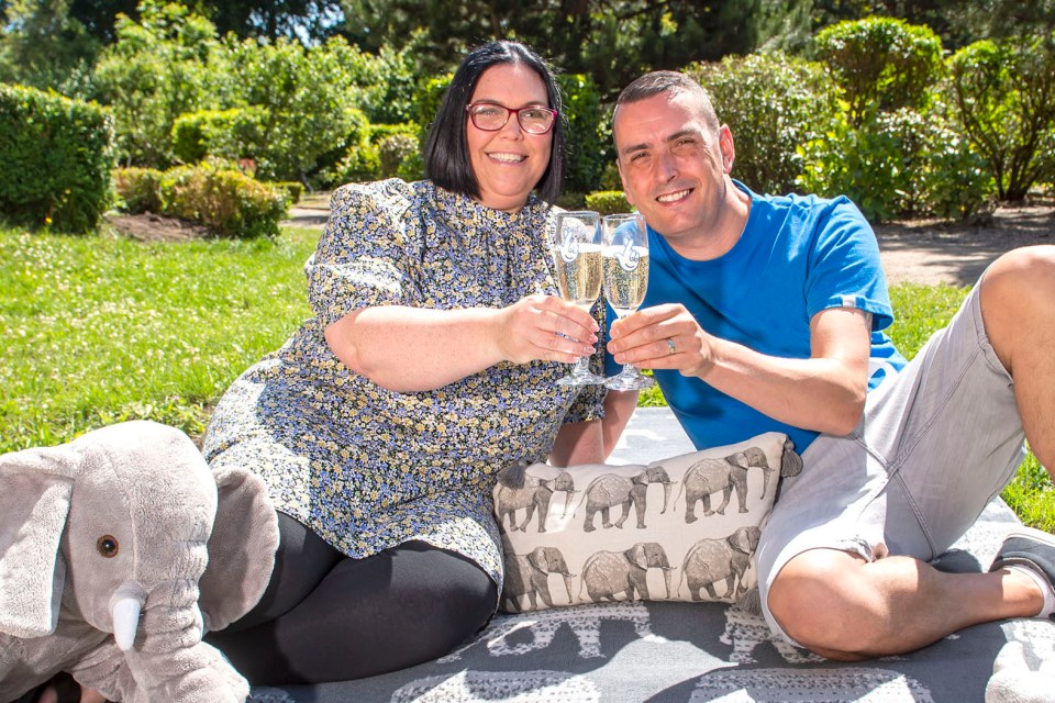 Louise and Stuart Tate pose with their lucky elephants as they celebrate winning £100,000 on a scratchcard