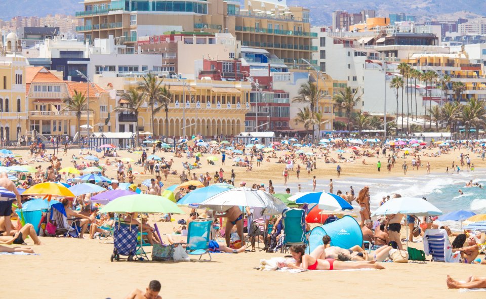 Sunseekers pack the city beach in Las Palmas on Gran Canaria in Spain